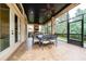 Covered patio with a brick floor, ceiling fan, and a full outdoor kitchen and dining space at 11856 Vinci Dr, Windermere, FL 34786