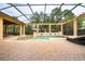 Backyard pool with attached spa featuring stone planter feature and screened enclosure at 11856 Vinci Dr, Windermere, FL 34786