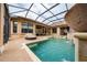 Backyard pool features a spa, waterfall feature, and a lounging deck beneath a screened enclosure at 11856 Vinci Dr, Windermere, FL 34786