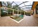 A backyard pool with an attached spa has an outdoor enclosure and stone planter feature at 11856 Vinci Dr, Windermere, FL 34786