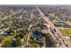 Wide aerial view of neighborhood showing mature trees, businesses, and the nearby waterway at 1205 Wisconsin Ave, St Cloud, FL 34769