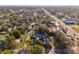 Wide aerial view of the home in the neighborhood with mature trees and businesses nearby at 1205 Wisconsin Ave, St Cloud, FL 34769