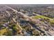 Wide aerial shot of neighborhood with mature trees, businesses, and proximity to water at 1205 Wisconsin Ave, St Cloud, FL 34769