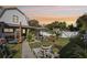 Well-manicured backyard features a spacious lawn, patio area, and mature tropical plants at sunset at 1205 Wisconsin Ave, St Cloud, FL 34769