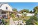 Well-manicured backyard features a spacious lawn, patio area, and mature tropical plants at 1205 Wisconsin Ave, St Cloud, FL 34769