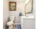 A well-lit bathroom with white vanity, modern fixtures, and light hardwood floors at 1205 Wisconsin Ave, St Cloud, FL 34769