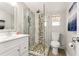 Modern bathroom features a glass-enclosed shower with decorative tile and a vanity with sink at 1205 Wisconsin Ave, St Cloud, FL 34769