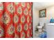 Bathroom featuring a vibrant shower curtain and a neatly arranged toilet and sink area at 1205 Wisconsin Ave, St Cloud, FL 34769