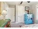 Charming bedroom showing closet doors, colorful floral dresser, carpet, and neutral wall paint at 1205 Wisconsin Ave, St Cloud, FL 34769
