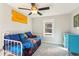 Cozy bedroom featuring a daybed with blue bedding and a window that provides lots of natural light at 1205 Wisconsin Ave, St Cloud, FL 34769