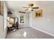 A modern bedroom features a fan, and a cozy workspace with ample natural light at 1205 Wisconsin Ave, St Cloud, FL 34769