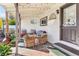 Charming covered patio area featuring outdoor seating, string lights, and a wall-mounted TV at 1205 Wisconsin Ave, St Cloud, FL 34769