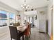 Bright dining room with modern chandelier, multiple windows, and open access to other living areas at 1205 Wisconsin Ave, St Cloud, FL 34769