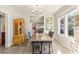 Charming dining room featuring a rustic wood table, bright windows, and a decorative china cabinet at 1205 Wisconsin Ave, St Cloud, FL 34769