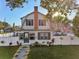 Charming two-story home featuring a well-manicured front yard and a white picket fence at 1205 Wisconsin Ave, St Cloud, FL 34769