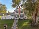 Charming two-story home featuring a well-manicured front yard and walkway at 1205 Wisconsin Ave, St Cloud, FL 34769