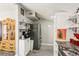 Cozy kitchen featuring open shelving, white cabinets, stainless steel appliances, and granite countertops at 1205 Wisconsin Ave, St Cloud, FL 34769