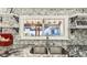 Modern kitchen sink area features decorative backsplash, floating shelves, and stylish decor at 1205 Wisconsin Ave, St Cloud, FL 34769