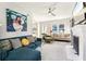 Inviting living room with bright windows, a ceiling fan, fireplace, and comfortable contemporary furnishings at 1205 Wisconsin Ave, St Cloud, FL 34769