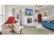 Comfortable living room with large screen television above the fireplace at 1205 Wisconsin Ave, St Cloud, FL 34769