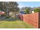 Spacious fenced backyard with red wooden fencing at 1205 Wisconsin Ave, St Cloud, FL 34769