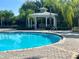 Community pool featuring a covered gazebo and clear blue water at 14320 Desert Haven St # 3906, Windermere, FL 34786