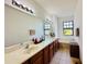 Bathroom features a long vanity with double sinks, large mirror and tile flooring at 1509 Portofino Meadows Blvd, Orlando, FL 32824