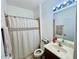 Bathroom featuring a shower with curtain and a sink with a mirror at 1509 Portofino Meadows Blvd, Orlando, FL 32824