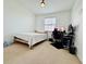 Bedroom features a bed, large window, and a desk with a computer setup at 1509 Portofino Meadows Blvd, Orlando, FL 32824