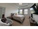 Bedroom with a ceiling fan, large windows, and a chair at 1509 Portofino Meadows Blvd, Orlando, FL 32824