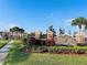 Stone community entrance sign amidst lush landscaping under a clear blue sky at 1509 Portofino Meadows Blvd, Orlando, FL 32824