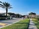 Gated community entrance featuring brick columns, mature landscaping, and a sidewalk at 1509 Portofino Meadows Blvd, Orlando, FL 32824