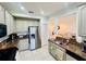 Charming kitchen featuring stainless steel appliances, granite countertops, and neutral cabinets at 1509 Portofino Meadows Blvd, Orlando, FL 32824
