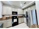 Well-lit kitchen with stainless steel appliances, granite counters, and ample cabinet space at 1509 Portofino Meadows Blvd, Orlando, FL 32824