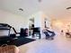 Bright open concept room that is perfect for exercise and entertaining with kitchen close by at 1509 Portofino Meadows Blvd, Orlando, FL 32824