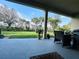 This covered patio boasts ample space with lush green backyard views, perfect for outdoor living and entertaining at 1509 Portofino Meadows Blvd, Orlando, FL 32824