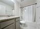 Cozy bathroom featuring a shower-tub combo and vanity with a granite countertop and ample storage at 1510 Chelsea Dr, Davenport, FL 33897