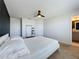 Bedroom featuring neutral walls, ceiling fan, and comfortable bed with an open bathroom view at 1510 Chelsea Dr, Davenport, FL 33897
