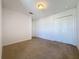 Neutral carpeted bedroom with ample natural light, a closet, and bright white paint at 1510 Chelsea Dr, Davenport, FL 33897