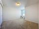 Neutral carpeted bedroom with ample natural light, a closet, and bright white paint at 1510 Chelsea Dr, Davenport, FL 33897