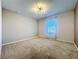 Bright bedroom with a large window, neutral carpet and a modern ceiling light fixture at 1510 Chelsea Dr, Davenport, FL 33897