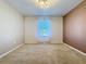 Carpeted bedroom features neutral walls, a window with blinds, and ample natural light at 1510 Chelsea Dr, Davenport, FL 33897