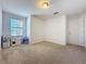 Neutral carpeted bedroom with ample natural light and bright white paint at 1510 Chelsea Dr, Davenport, FL 33897