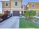 Inviting townhome featuring a well-kept lawn, landscaping, and an attached single-car garage at 1510 Chelsea Dr, Davenport, FL 33897