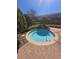 Secluded community hot tub features refreshing water, landscaping, brick trim, and nearby building access at 1510 Chelsea Dr, Davenport, FL 33897