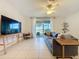 Comfortable living room featuring tile flooring, ceiling fan, and sliding door with outdoor views at 1510 Chelsea Dr, Davenport, FL 33897