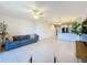 A modern living room with tile floors, neutral walls, and a view of the connecting kitchen area at 1510 Chelsea Dr, Davenport, FL 33897