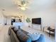 Open living room and kitchen with tile floors, ceiling fan, and modern furnishings at 1510 Chelsea Dr, Davenport, FL 33897