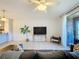 Bright living room featuring tile floors, ceiling fan, and sliding glass doors to the backyard at 1510 Chelsea Dr, Davenport, FL 33897