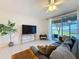 Inviting living room with tile floors, a large sliding door to the patio, and a ceiling fan at 1510 Chelsea Dr, Davenport, FL 33897